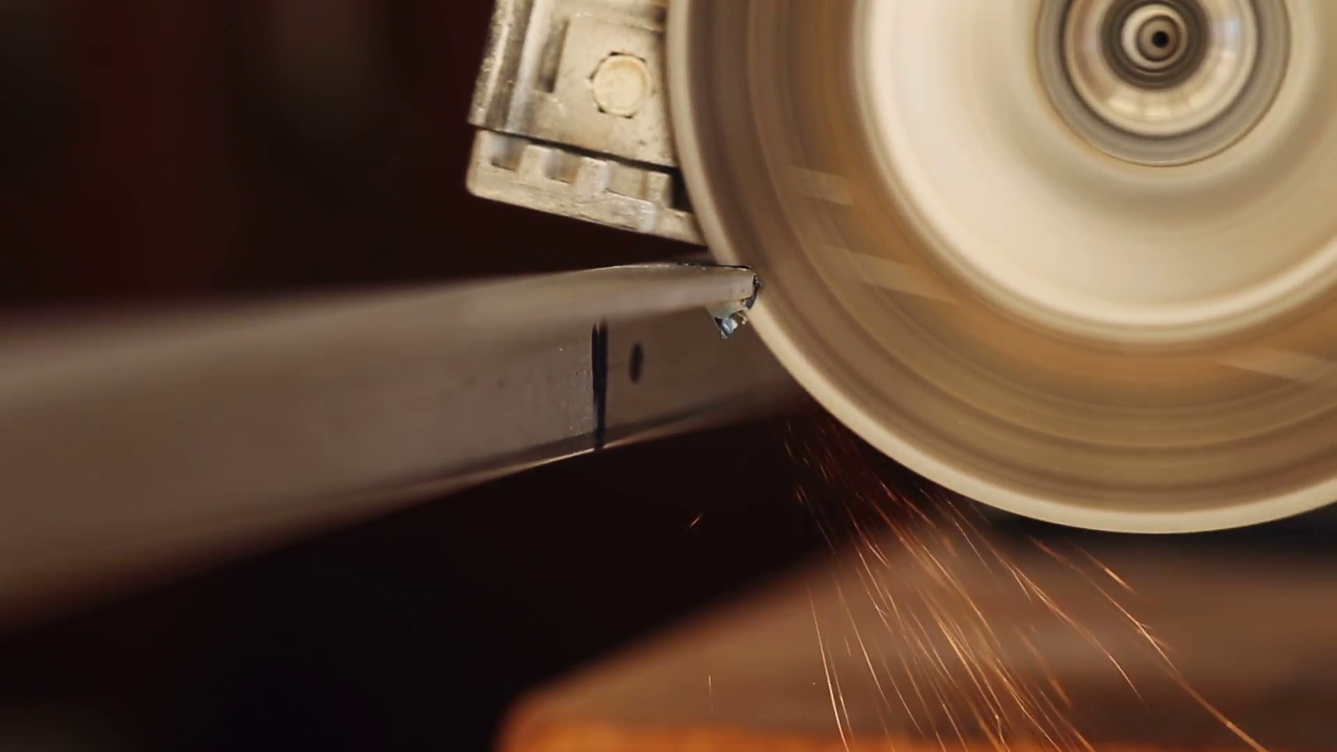 close-up-view-of-a-circular-saw-cutting-a-piece-of-angle-iron-with-sparks-flying_ekrhhxesx__F0000